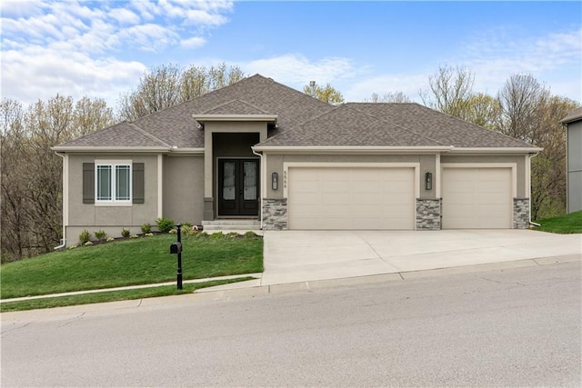 5566 Thousand Oaks Dr, Parkville, MO 64152 - prairie-style house featuring stucco siding, driveway, stone siding, a front yard, and an attached garage