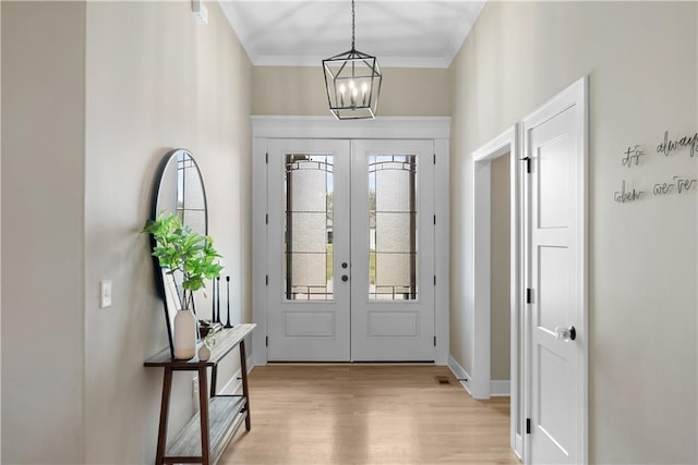 5566 Thousand Oaks Dr, Parkville, MO 64152 - foyer entrance with french doors, light wood-type flooring, a chandelier, and baseboards