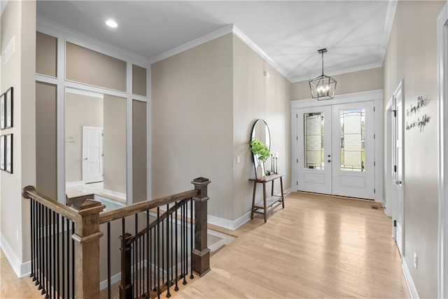 5566 Thousand Oaks Dr, Parkville, MO 64152 - foyer with an inviting chandelier, light wood-style floors, french doors, and ornamental molding