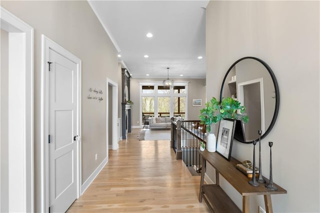 5566 Thousand Oaks Dr, Parkville, MO 64152 - hallway with light wood-type flooring, recessed lighting, a notable chandelier, and baseboards