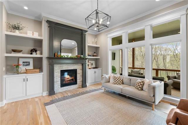 5566 Thousand Oaks Dr, Parkville, MO 64152 - living room featuring light wood-type flooring, ornamental molding, and a stone fireplace