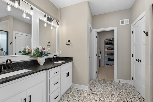 5566 Thousand Oaks Dr, Parkville, MO 64152 - bathroom with visible vents, a shower stall, double vanity, and a sink