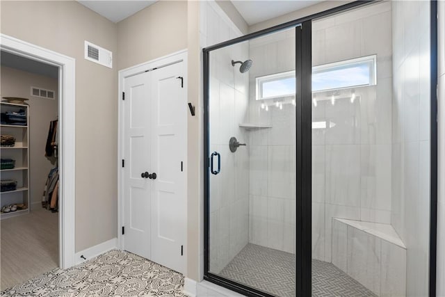 5566 Thousand Oaks Dr, Parkville, MO 64152 - bathroom featuring a walk in closet, visible vents, a stall shower, and baseboards