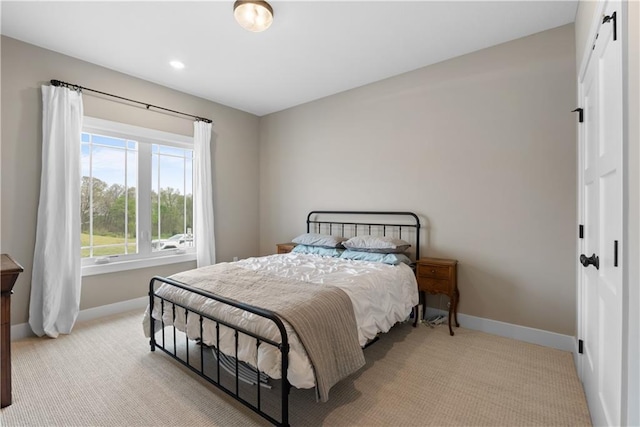 5566 Thousand Oaks Dr, Parkville, MO 64152 - bedroom featuring baseboards, a barn door, a closet, and light colored carpet