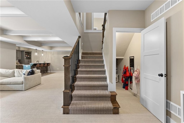 5566 Thousand Oaks Dr, Parkville, MO 64152 - stairway with visible vents, bar, carpet floors, and baseboards