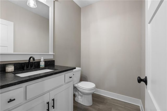 5566 Thousand Oaks Dr, Parkville, MO 64152 - half bath featuring wood finished floors, toilet, vanity, and baseboards