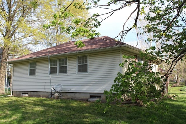 view of side of property with a yard