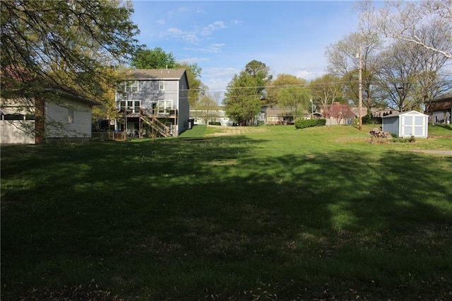 view of yard featuring a storage shed and an outbuilding