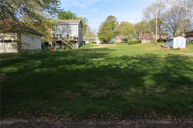 view of yard with a storage shed and an outbuilding