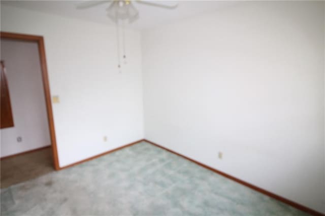 unfurnished room featuring baseboards, carpet, and a ceiling fan