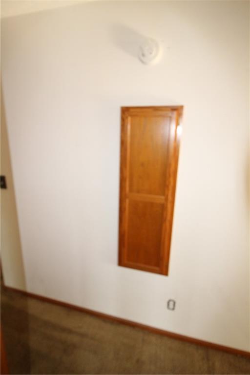 unfurnished room featuring baseboards
