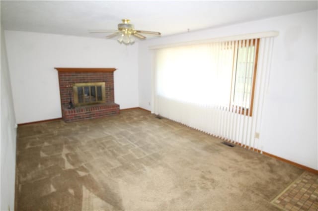 1211 Spruce St, Eudora, KS 66025 - unfurnished living room featuring carpet, plenty of natural light, and a ceiling fan