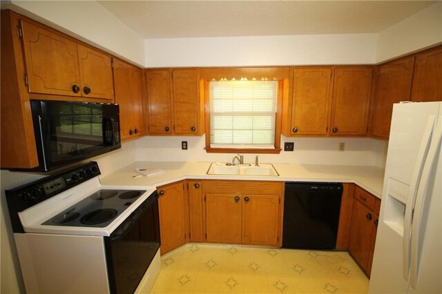 1211 Spruce St, Eudora, KS 66025 - kitchen featuring black appliances, a sink, brown cabinets, and light countertops
