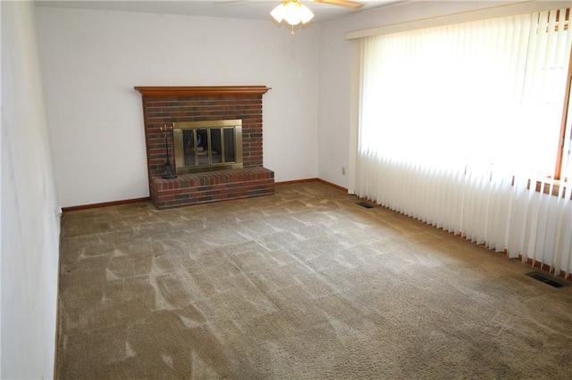 1211 Spruce St, Eudora, KS 66025 - unfurnished living room featuring carpet, a ceiling fan, a fireplace, and baseboards