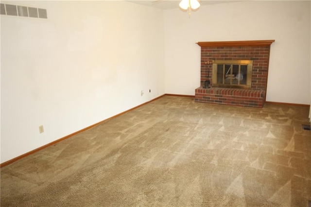1211 Spruce St, Eudora, KS 66025 - unfurnished living room with carpet flooring, ceiling fan, baseboards, and a brick fireplace