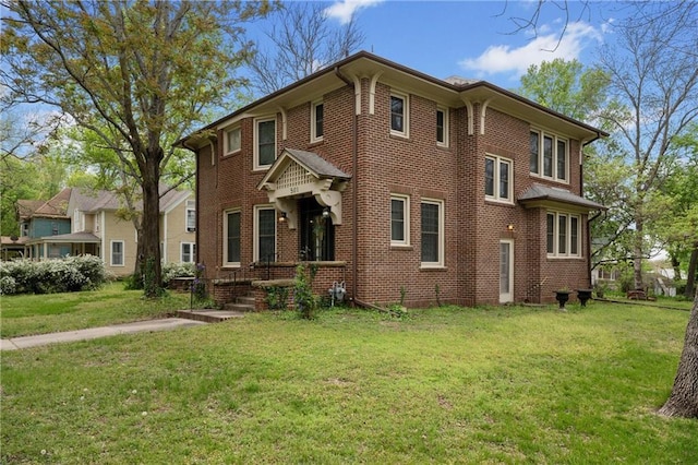 view of front of home featuring a front lawn and brick siding