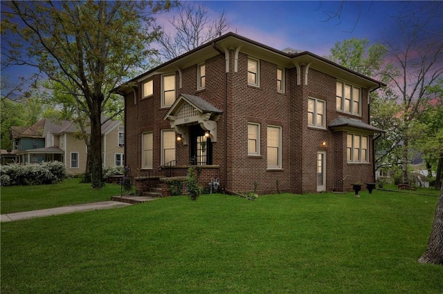 view of front of house with brick siding and a front yard