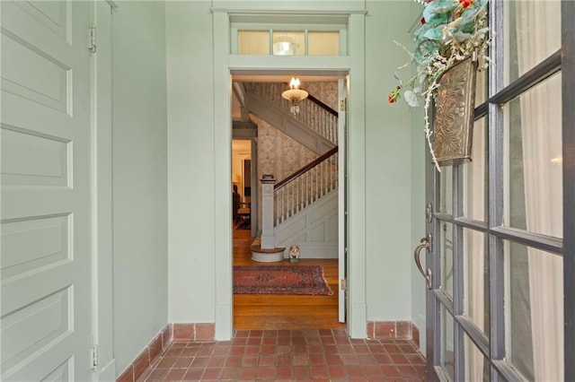 hall featuring stairway, baseboards, and tile patterned floors