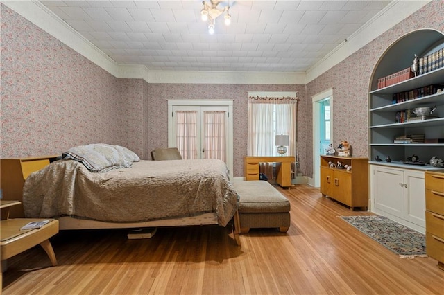 bedroom with light wood finished floors, wallpapered walls, and ornamental molding