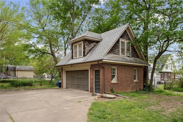 view of property exterior featuring fence, brick siding, roof with shingles, and cooling unit