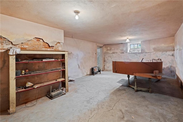 below grade area with a textured ceiling