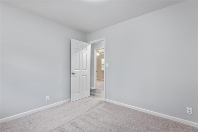 empty room with baseboards and carpet