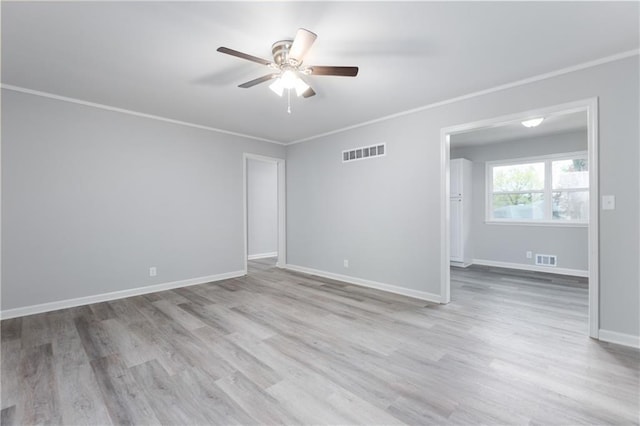 spare room featuring visible vents, ceiling fan, and wood finished floors