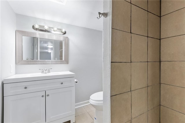 bathroom with toilet, tile patterned flooring, and vanity