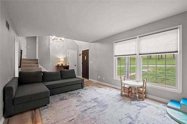 28274 W 311th St, Paola, KS 66071 - living area with wood finished floors, stairs, and lofted ceiling
