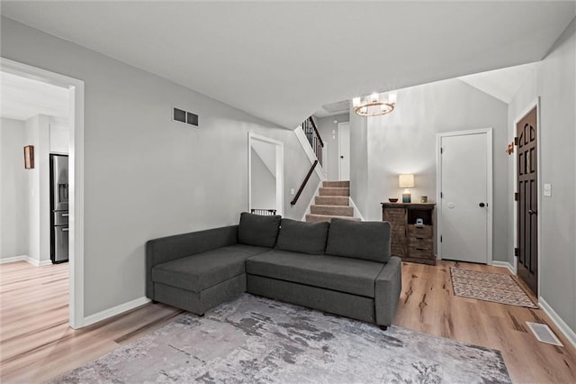 28274 W 311th St, Paola, KS 66071 - living area with light wood-style flooring, stairs, and a chandelier