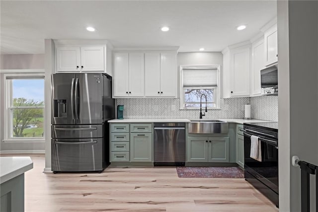 28274 W 311th St, Paola, KS 66071 - kitchen with stainless steel appliances, light wood-type flooring, white cabinetry, light countertops, and recessed lighting