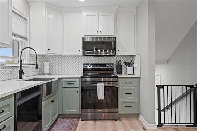 28274 W 311th St, Paola, KS 66071 - kitchen featuring appliances with stainless steel finishes, light wood-type flooring, light countertops, and backsplash