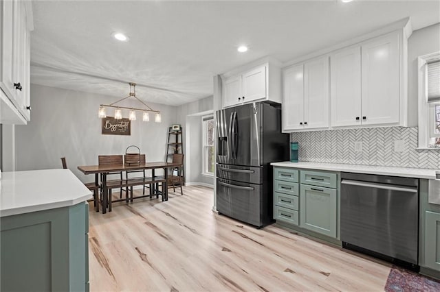 28274 W 311th St, Paola, KS 66071 - kitchen featuring appliances with stainless steel finishes, white cabinets, green cabinets, light countertops, and recessed lighting
