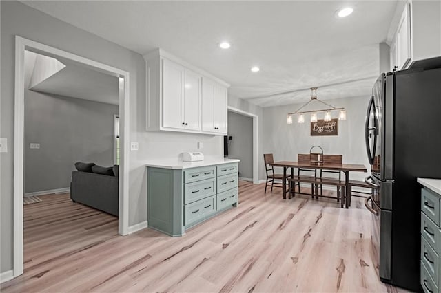 28274 W 311th St, Paola, KS 66071 - kitchen featuring freestanding refrigerator, white cabinetry, light wood-type flooring, light countertops, and recessed lighting