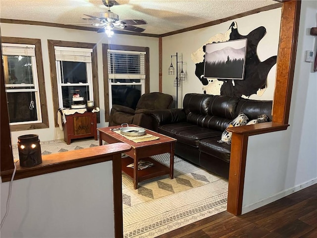 living area featuring ornamental molding, a textured ceiling, ceiling fan, and wood finished floors