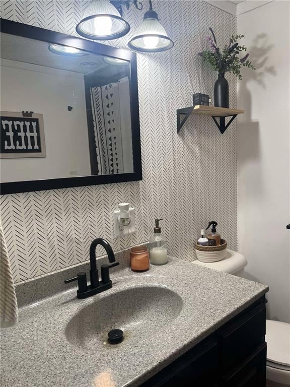 bathroom featuring toilet and vanity