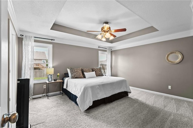12200 E 214th Ter, Peculiar, MO 64078 - carpeted bedroom featuring a raised ceiling, baseboards, ceiling fan, and a textured ceiling