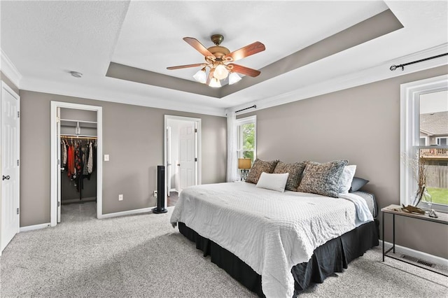 12200 E 214th Ter, Peculiar, MO 64078 - bedroom with a raised ceiling, carpet, baseboards, a walk in closet, and a closet