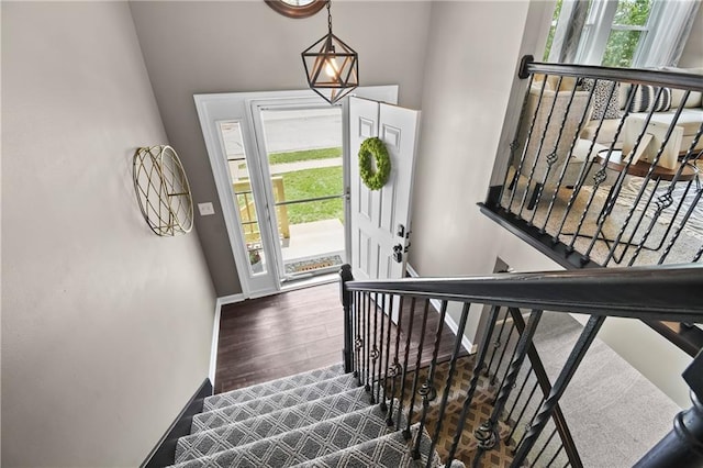 12200 E 214th Ter, Peculiar, MO 64078 - foyer with healthy amount of natural light, wood finished floors, baseboards, and stairway