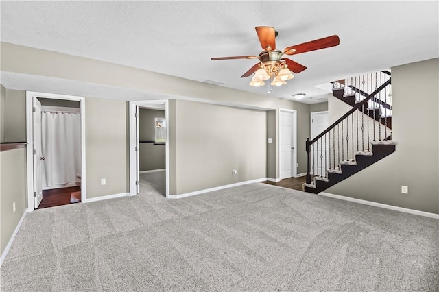 12200 E 214th Ter, Peculiar, MO 64078 - unfurnished living room featuring carpet flooring, stairway, baseboards, and a ceiling fan
