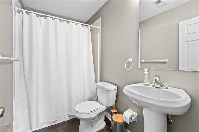 12200 E 214th Ter, Peculiar, MO 64078 - bathroom with toilet, wood finished floors, and shower / bath combo with shower curtain