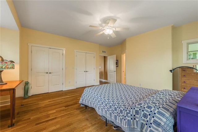 8725 Nebo Hills Rd, Liberty, MO 64068 - bedroom with visible vents, baseboards, multiple closets, and wood finished floors