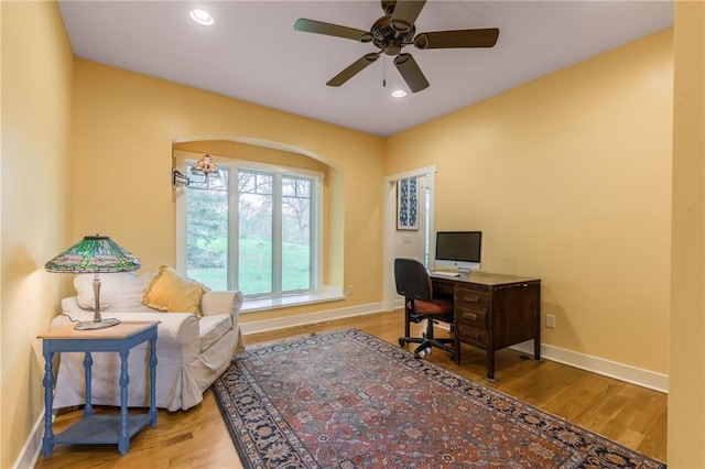 8725 Nebo Hills Rd, Liberty, MO 64068 - home office with a ceiling fan, wood finished floors, baseboards, recessed lighting, and arched walkways