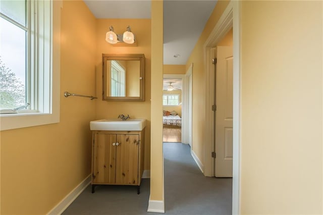 8725 Nebo Hills Rd, Liberty, MO 64068 - bathroom featuring baseboards, a ceiling fan, and vanity