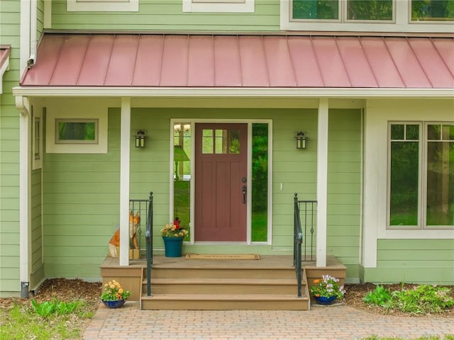8725 Nebo Hills Rd, Liberty, MO 64068 - doorway to property featuring metal roof, covered porch, and a standing seam roof