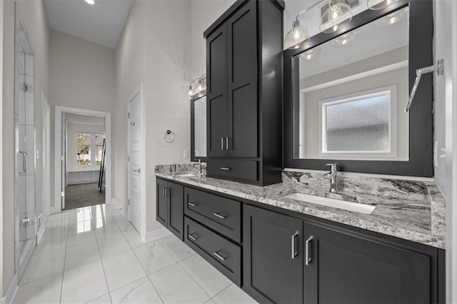 6309 NW 58th Ter, Kansas City, MO 64151 - bathroom featuring double vanity, marble finish floor, baseboards, and a sink