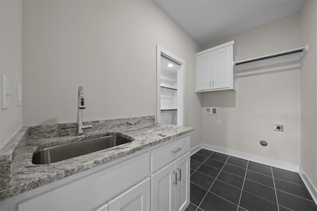 6309 NW 58th Ter, Kansas City, MO 64151 - laundry area featuring a sink, hookup for an electric dryer, hookup for a washing machine, cabinet space, and dark tile patterned floors