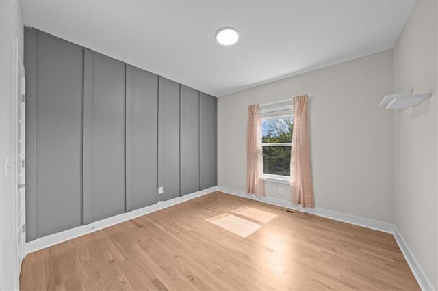 6309 NW 58th Ter, Kansas City, MO 64151 - spare room with light wood-style floors, visible vents, and baseboards