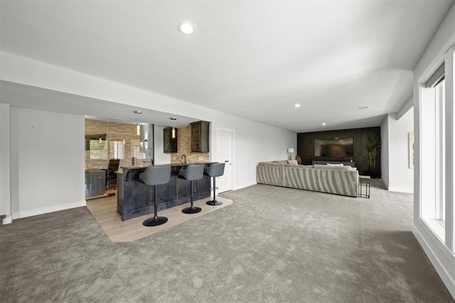 6309 NW 58th Ter, Kansas City, MO 64151 - living area featuring baseboards, carpet flooring, and recessed lighting
