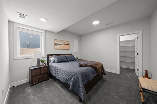 6309 NW 58th Ter, Kansas City, MO 64151 - carpeted bedroom with baseboards, visible vents, recessed lighting, and a walk in closet